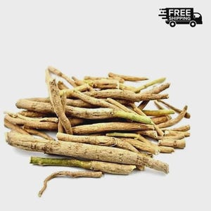 May include: A pile of dried, light brown ashwagandha roots with green tips. The roots are of varying lengths and thicknesses, with a rough, textured appearance. The image is set against a plain white background.