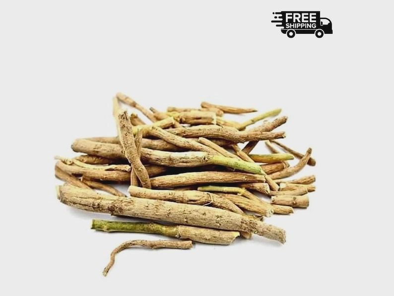 May include: A pile of dried, light brown ashwagandha roots with green tips. The roots are of varying lengths and thicknesses, with a rough, textured appearance. The image is set against a plain white background.