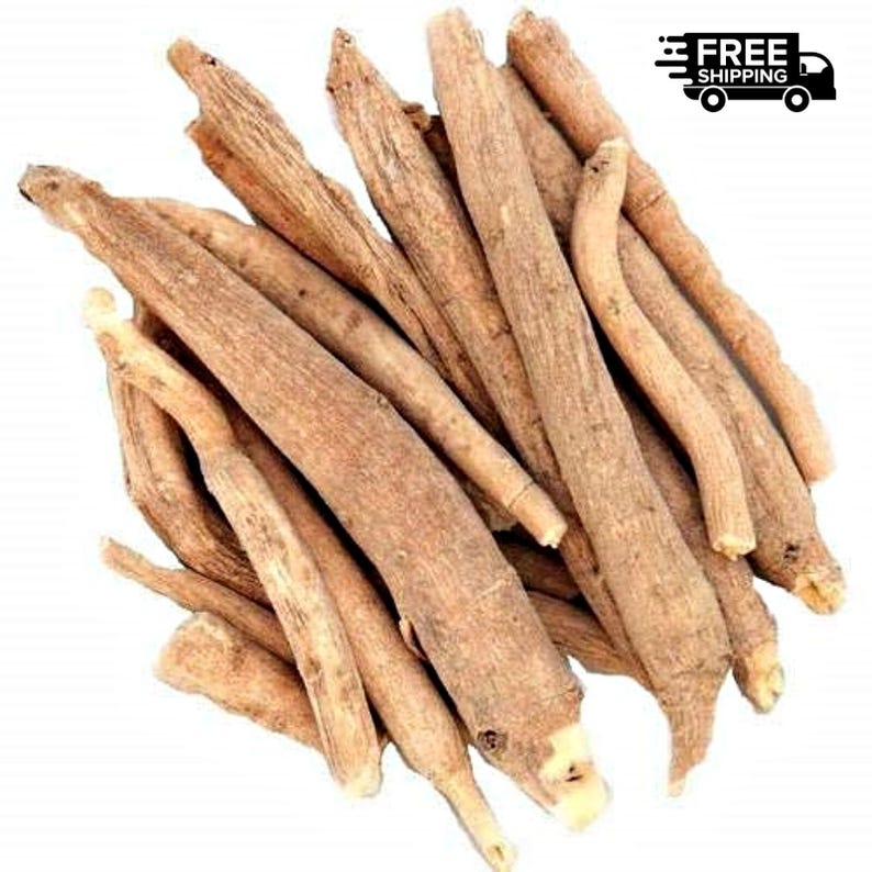 May include: A pile of dried, light brown ashwagandha roots. The roots are long, cylindrical, and have a rough texture. The image is taken from a top-down perspective, showcasing the natural color and form of the herbal product.