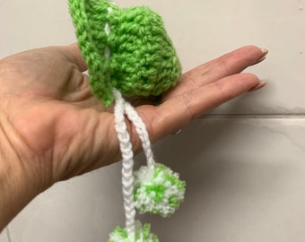 Green bonnet with pom-poms ties. Please check measurements in photos and postage details.