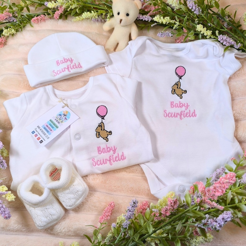 personalised girls sleepsuit with embroidered winnie the pooh design in pink