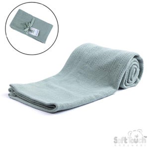 May include: A light green baby blanket, partially rolled and partially folded. The blanket has a textured weave and is displayed on a white background. A smaller, folded version of the blanket is shown in a circular inset, tied with a ribbon.