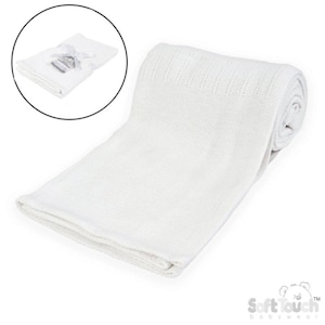 May include: A white baby blanket, folded and rolled, with a textured knit pattern. The blanket is displayed on a white background. A smaller, folded version is shown in a circular inset. The blanket is made of soft material.