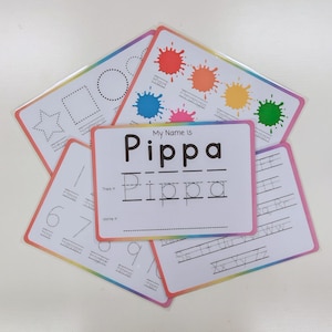 May include: A collection of educational practice cards with a rainbow border. One card features the text My Name Is Pippa with a tracing line and a blank line. Other cards show shapes, colour splatters with labels, numbers, and alphabet letters.