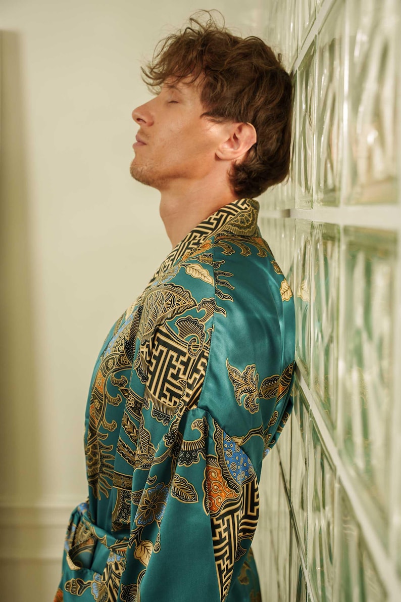Close up of a man wearing teal satin kimono robe handmade in Bali. Long dressing gown is perfect gift for anniversaries, birthdays, christmas.