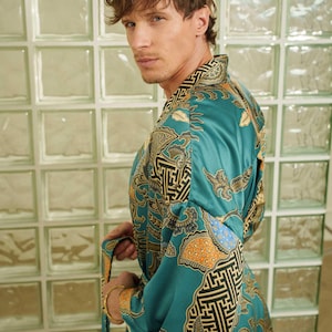 Man wearing teal satin kimono robe handmade in Bali. Long dressing gown is perfect gift for anniversaries, birthdays, christmas.