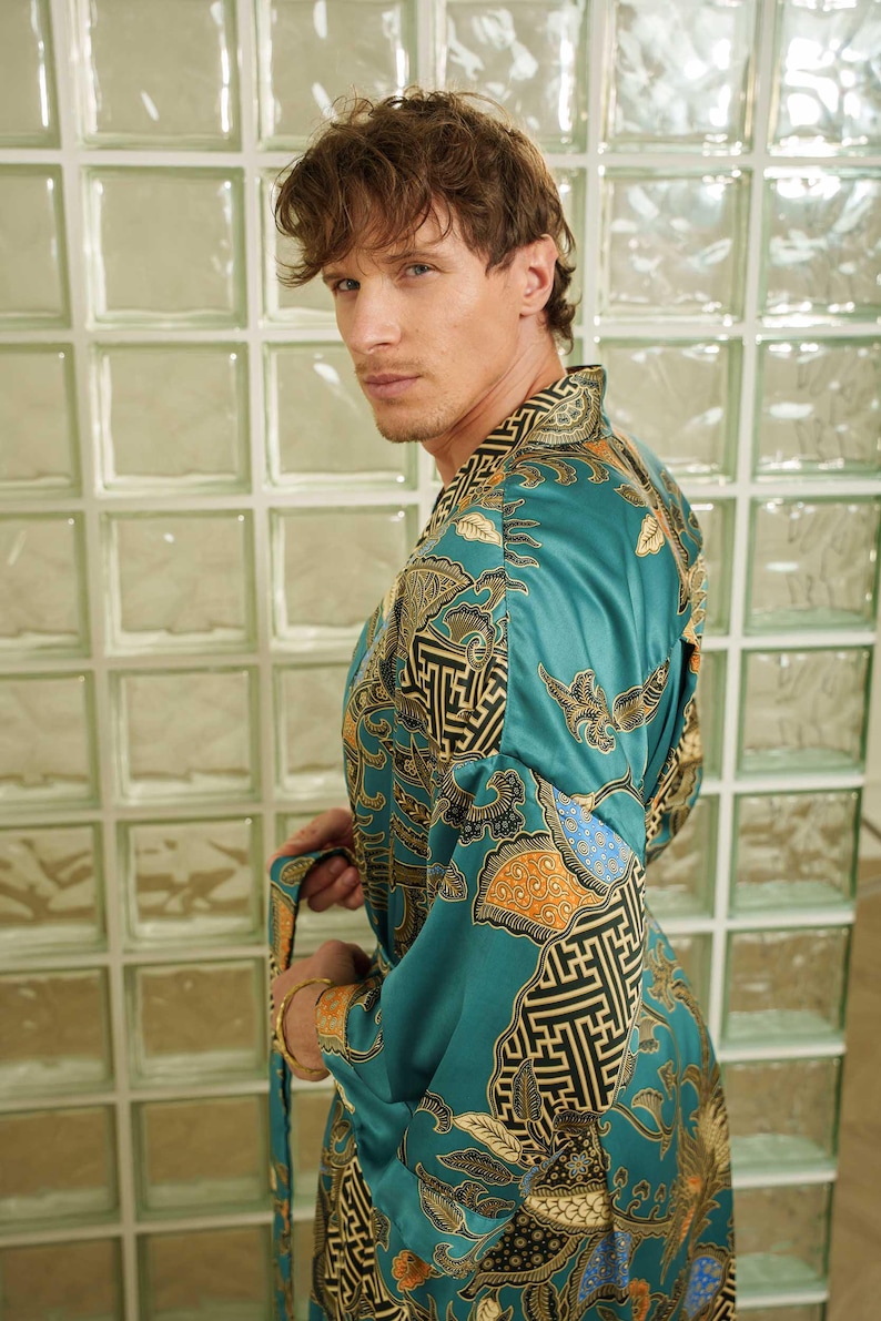 Man wearing teal satin kimono robe handmade in Bali. Long dressing gown is perfect gift for anniversaries, birthdays, christmas.