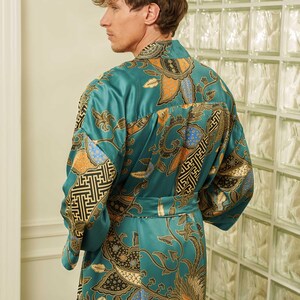 Back view of a Man wearing teal satin kimono robe handmade in Bali. Long dressing gown is perfect gift for anniversaries, birthdays, christmas.