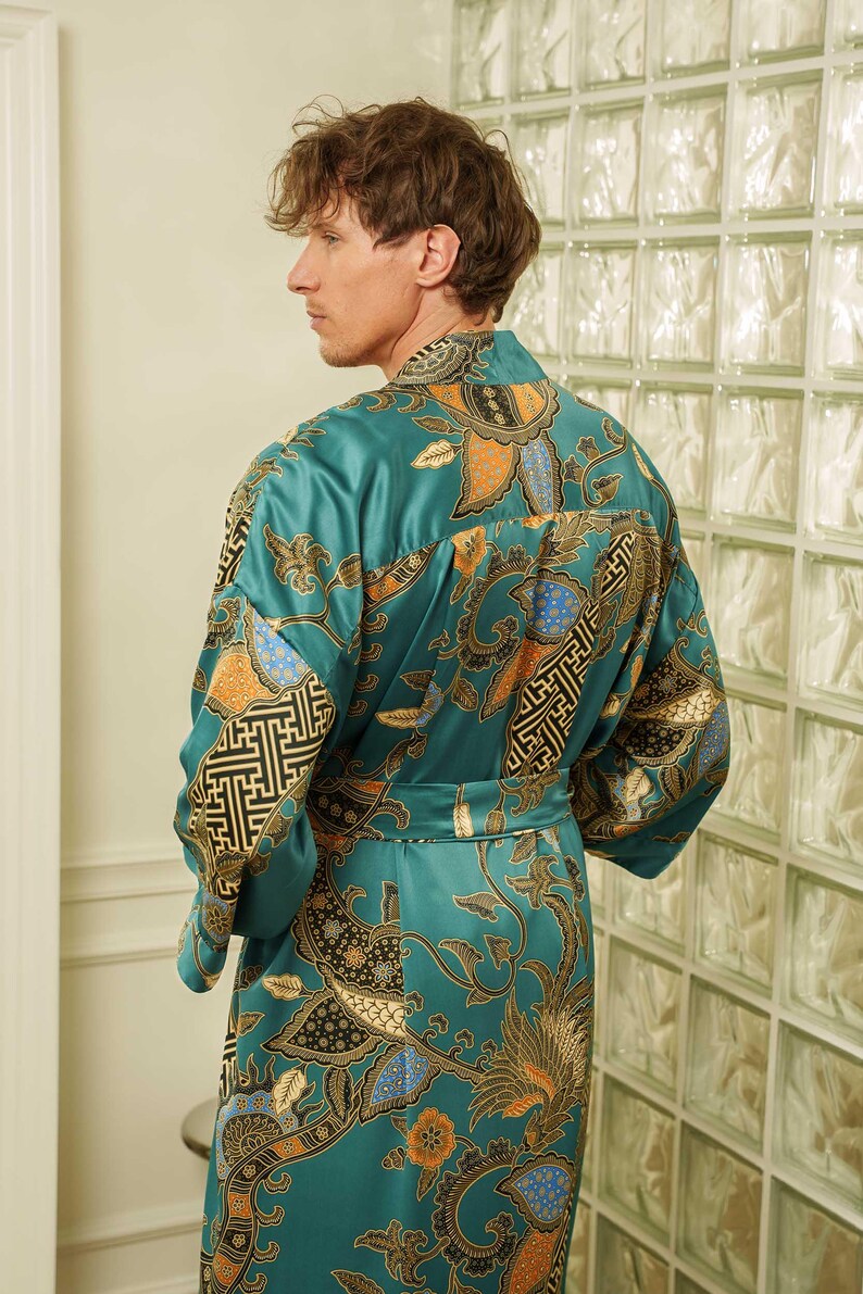 Back view of a Man wearing teal satin kimono robe handmade in Bali. Long dressing gown is perfect gift for anniversaries, birthdays, christmas.