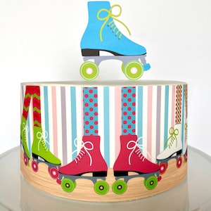 May include: A white cake decorated with a blue roller skate topper and a colorful roller skate border. The border features pink, green, and white roller skates with colorful striped and polka dot socks.