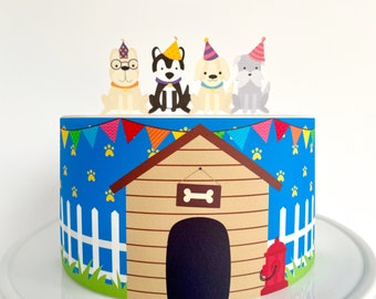 May include: A blue and brown dog house cake topper with four dogs wearing party hats. The cake topper is decorated with colorful flags and paw prints.