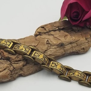 Bracelet Damascène vintage articulé avec des oiseaux décorés en or sur des panneaux noirs