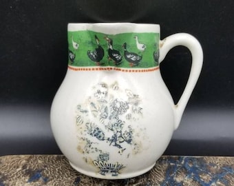 Antique French Ironstone Jug with Side Handle Detail.  White Faience with Rustic Image And Green Neck Decorated with White and Black Ducks.