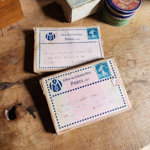May include: Two vintage blue and white paper envelopes with the text "4 Rue du Colonel Moll PARIS (175)" and "MLE BILTELE FLIMLIN J2XUE MASSEY PYREN" printed on them.