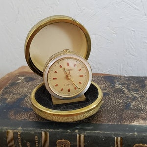 Vintage German Made Deluxe 7 Jewels Travel Clock With Silver Edge Detail And Gold Face. Closing Case Small Travel Clock