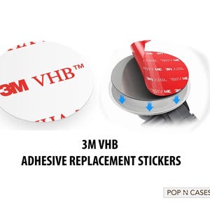 May include: Two white round 3M VHB adhesive replacement stickers. The sticker on the left shows the 3M VHB logo in red. The sticker on the right is partially peeled back to show the red adhesive.