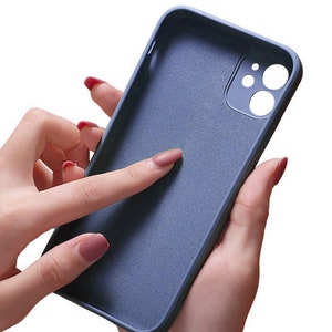 May include: A blue silicone phone case with a microfiber lining to protect the back of the phone from scratches. The case has a raised camera bump to protect the lenses.