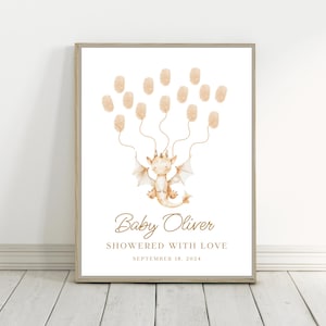 May include: A white printable baby shower guest book with a cute cartoon dragon holding balloons. The text reads "Baby Oliver Showered with Love September 18, 2024".