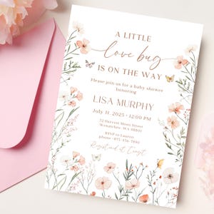 May include: A baby shower invitation featuring floral and butterfly designs. The invitation text reads "A little love bug is on the way" and includes details for Lisa Murphy's baby shower, including the date, time, and location.