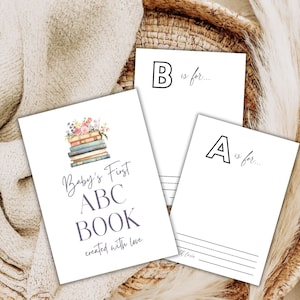 May include: A printable baby's first ABC book with a stack of books and flowers on the cover. The text reads "Baby's First ABC Book created with love".