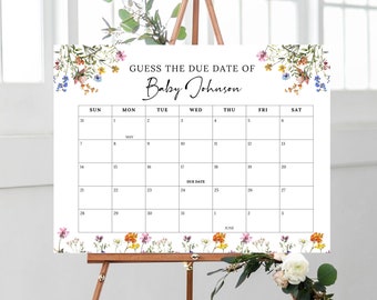 Könnte beinhalten: Ein weißer Kalender mit floralen Rändern, betitelt "Erraten Sie das Geburtstermin von Baby Johnson". Der Kalender ist für Mai und Juni, wobei der Geburtstermin auf den 24. Mai hervorgehoben ist.