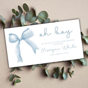 May include: A baby shower invitation with a light blue watercolor bow and the words "oh boy." The invitation includes the text "Please join us for a baby sprinkle honoring Morgan White, November 11, 2024."