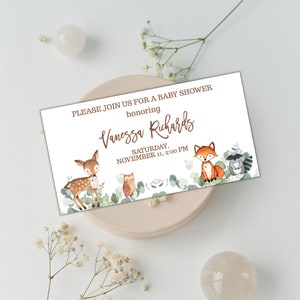 May include: A white baby shower invitation with a brown border. The invitation features a deer, owl, fox, and raccoon surrounded by green leaves. The text on the invitation reads "PLEASE JOIN US FOR A BABY SHOWER honoring Vanessa Richards SATURDAY, NOVEMBER 11, 2:00 PM".