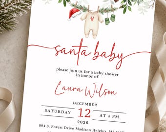 May include: A white baby shower invitation card featuring a watercolor illustration of a clothesline with a Santa hat, a cream-colored onesie with a red deer print, and green mittens. The text reads Santa baby, Laura Wilson, December 12, 2026.