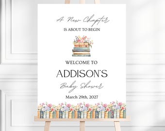 May include: A white rectangular sign on a wooden easel featuring the text A New Chapter IS ABOUT TO BEGIN, WELCOME TO ADDISON'S Baby Shower, and March 29th, 2027. The design includes a stack of books topped with flowers and a bottom border of books.