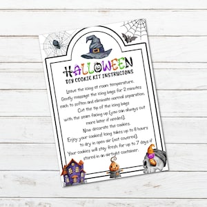 May include: A Halloween-themed DIY cookie kit instructions sheet. The top of the sheet features a witch's hat, spiderwebs, and a bat. The text reads "Halloween DIY Cookie Kit Instructions". The bottom of the sheet has illustrations of a haunted house, a pumpkin, and a skull.