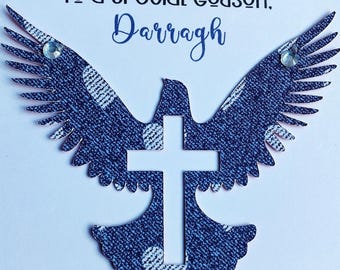 May include: A white card with blue and white patterned dove with a white cross in the center. The card says "To a special godson, Darragh".