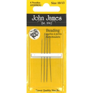 May include: A pack of four John James beading needles, size 10/13. The pack is yellow with a black and white illustration of a dragon. The text "Beading" is printed in black on a white background.