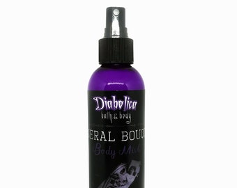 May include: A purple bottle of "Diabolica bath & body" "Herbal Bouquet Body Mist". The bottle has a black spray nozzle and a black label with white text.
