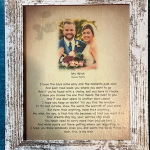 May include: A white framed print with a wedding photo of a couple and a poem by Rascal Flatts titled "My Wish". The poem reads, "I hope the days come easy and the moments pass slow...Yeah, this, is my wish."