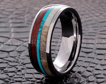 May include: A silver tungsten carbide ring with a black inlay and a band of brown wood, white bone, and turquoise.