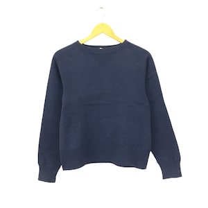 May include: A navy blue sweatshirt with a crew neck and long sleeves.