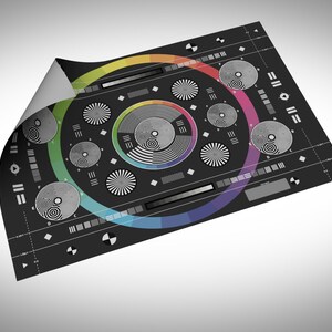 May include: A black and white colour chart with a rainbow circle in the centre. The chart includes a variety of patterns and shapes for testing camera and printer colour accuracy.