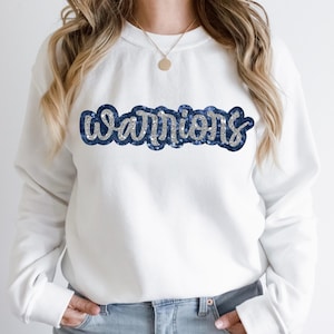 May include: White sweatshirt with a blue and silver sequined "WARRIORS" graphic.