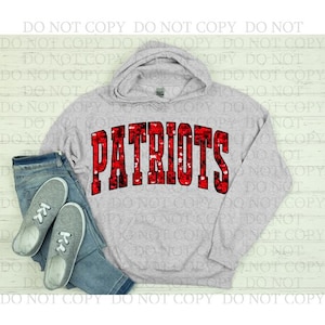 May include: A light gray hoodie with the word "PATRIOTS" in large, red, sequined letters across the front. The hoodie is paired with blue jeans and gray sneakers.