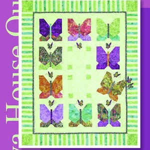 May include: A colorful quilt titled "Butterfly's Break" featuring nine butterfly designs in shades of purple, orange, and green. The quilt is 50" x 62" and has a green and white striped border. The text "Java House Quilts" is also visible.