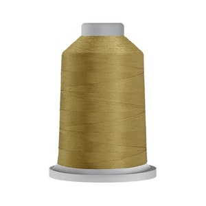 May include: A spool of gold thread for sewing or embroidery.