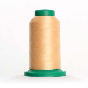 May include: A spool of beige thread with a green plastic top and bottom. The thread is wound around a plastic bobbin.
