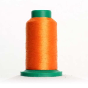 May include: A spool of bright orange thread with a green plastic top and bottom.