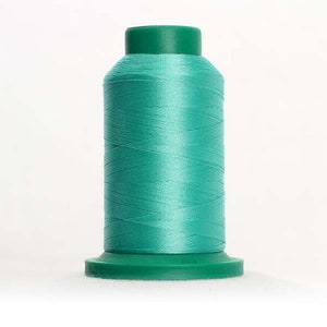 May include: A spool of teal green thread with a plastic base.