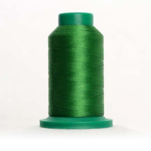 May include: A spool of bright green thread with a plastic bobbin.