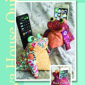 May include: A promotional image for "Remote Toads," 5 1/2-inch quilted bean bag toads designed to hold phones, remotes, and sewing tools. The toads are colorful, with button accents and large, googly eyes. The image includes a remote control and a smartphone.