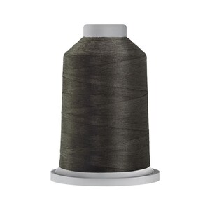 May include: A spool of dark gray thread for sewing or embroidery.