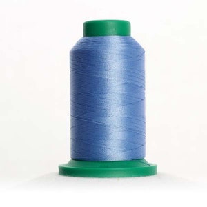 May include: A spool of light blue thread with a green plastic top and bottom.