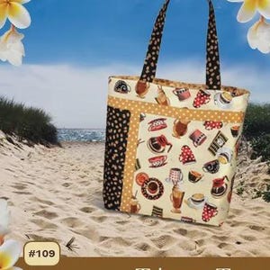 May include: A beige tote bag with a coffee-themed pattern, black polka dot accents, and brown handles. The bag is labeled "Tahoe Tote" and includes the text "Easy to Make • Lots of Pockets". The background shows a beach scene.