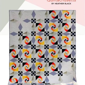 May include: A handmade quilt with a geometric pattern in shades of gray, black, navy, yellow, and red. The quilt measures 60" x 72" and features the text "SUNSET at SEA". The quilt is labeled "Intermediate".
